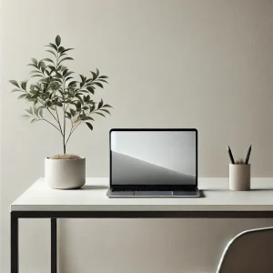 A minimalist image of a plant, laptop, cup with pens on a desk.